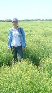 Dr. Yunfei Jiang standing in a field.