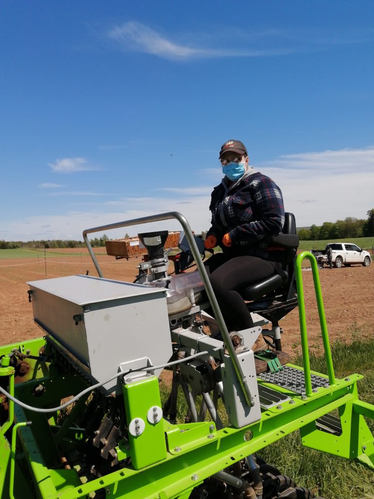 Man seeding with a tractor. 